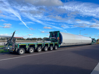 Transportation of oversized cargo. Loading, transporting and unloading a large column for wind...