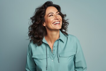 Portrait of a happy woman in her 40s sporting a vented fishing shirt against a pastel gray background. AI Generation