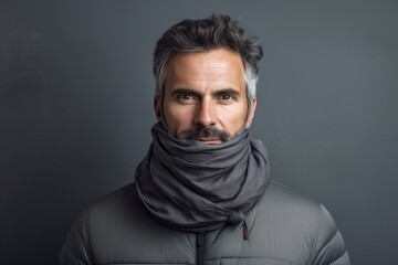 Portrait of a blissful man in his 40s wearing a protective neck gaiter against a soft gray background. AI Generation