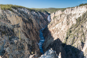 view of the Lower Falls and  Grand Canyon of Yellowstone from Artist Point on a sunny morning, Wyoming, USA
