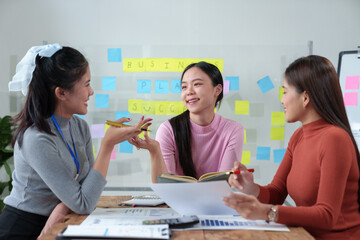 Happy Asian businesswoman working together in office Brainstorming meeting of the online internet technology creative team Business partners or teamwork concept of colleagues in office.