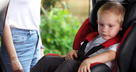 Child in Safety Car Seat. Baby on the Car. Preparing Kid for a Trip. Children Transportation Safety Concept.