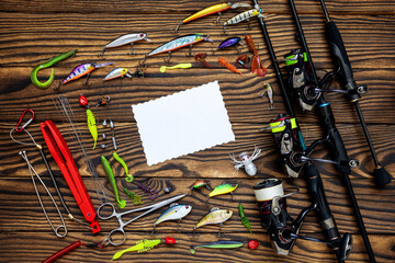 Fishing tackle on a wooden background. Fisherman Gear for catching Fish. 