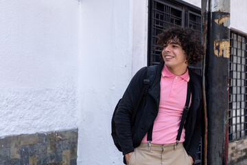 Young Latin American male university student standing with relaxed posture and smiling