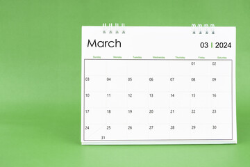 March 2024 desk calendar isolated in green background.