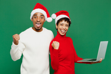 Merry fun winner young couple friends IT man woman wear red casual clothes Santa hat posing work...
