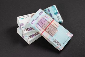 a pack of hryvnias on the table. Financial concept. Ukrainian money. 1000 hryvnia on dark background.