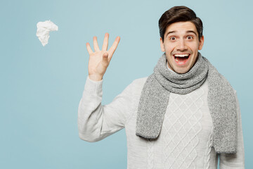 Young fun ill sick man wear gray sweater scarf throw away paper napkin tissue isolated on plain...