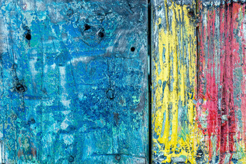 Aged and colorful grunge texture of shabby paint on a wooden surface