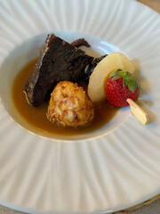 home cooking delicious veal chuck with mashed potato and pear and strawberry plum skewer