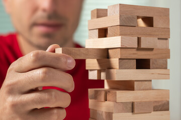 Planning, risk and strategy in business, businessman and engineer gambling placing wooden block on...