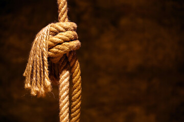 Noose in prison of old castle cellar and grunge stone wall close up