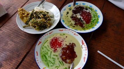 Jenang campur or Mix it up. The Indonesian dessert consists of green hunkwe pudding, red sago tapioca pearls, and cassava fermented in coconut milk sauce sweetened with brown sugar syrup.