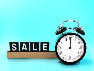 sign with the word sale and alarm clock. sale concept background