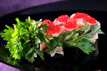 Sandwiches with red caviar, decorated with herbs on a dark background. Delicious Healthy food Breakfast lunch dinner