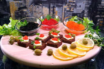  Black red caviar on sandwiches, decorated with greenery. Restaurant food breakfast dinner lunch