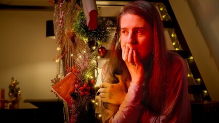 Police car lights illuminating the face of nervous and scared woman on Christmas night. Crime,...