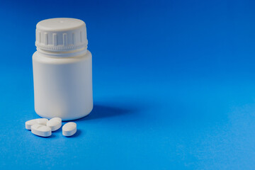 Close-up of a prescription pill bottle on a light blue background.