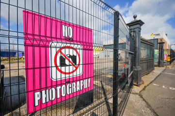 No photography sign on a fence at a movie studio.