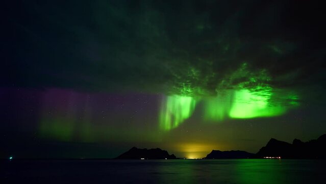 As the curtain of clouds closes over Ureddplassen in Gildesk&aring;l, the last aurora of the night is dancing vividly.
