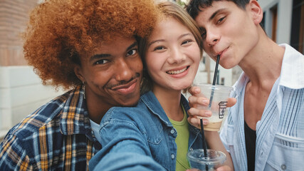 Close up, group of happy friends, two guys and girl, taking selfie on mobile phone