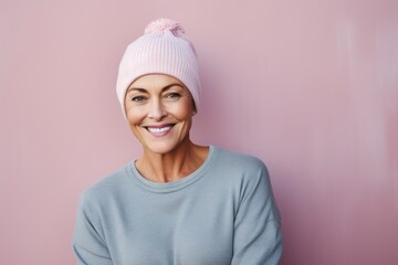 Portrait of a satisfied woman in her 50s donning a warm wool beanie against a solid pastel color wall. AI Generation