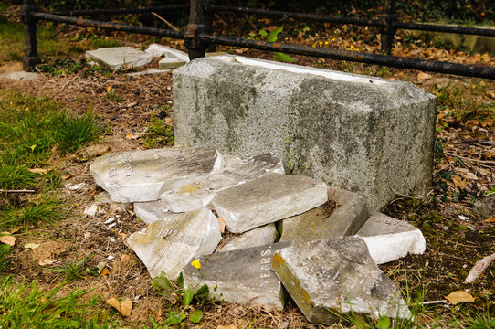 Broken gravestone in a cemetery after it has been vandalised