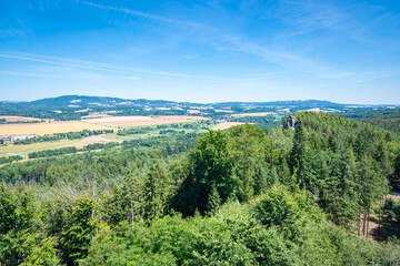Fototapeta na wymiar Hilly and partly forested landscape of Bohemia in Czech Republic on a sunny summer day