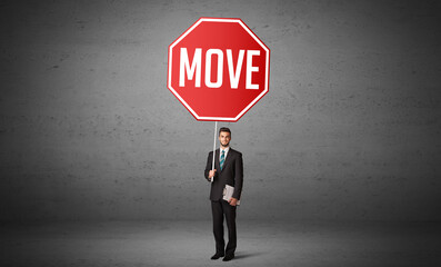 Young business person holding road sign