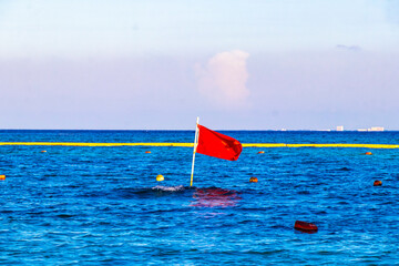 Red flag swimming prohibited high waves Playa del Carmen Mexico.