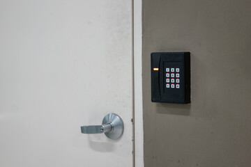The digital locking keypad with number dial that installed on the wall closed to the locked door....