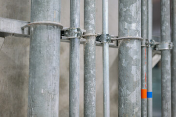 Close-up at steel pipeline that installed on the concrete wall in building interior.