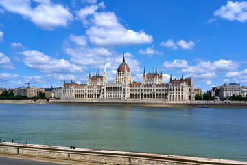 Hungarian Parliament Building on a summer day as seen from the opposing bank of the Danube river in central Budapest, Hungary.