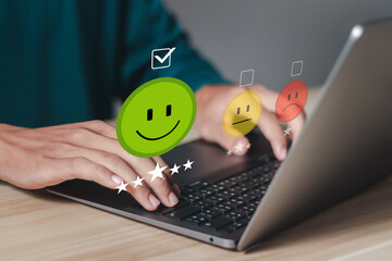 Businessmen use laptop and rate satisfaction by smiling face for satisfaction experience rating and...