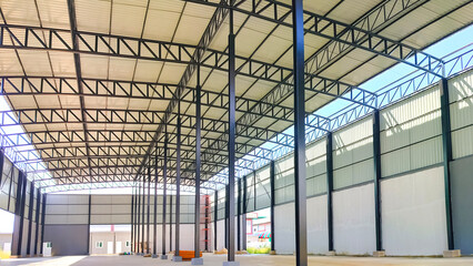 Corrugated steel roof with metal roof beam and columns of new warehouse building structure is under construction, view from inside and perspective side view