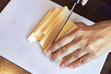 Slicing cheese close up