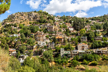 Fototapeta na wymiar Picturesque of houses that are built on the mountain slopes in the mountainous region of Faraya. Republic of Lebanon