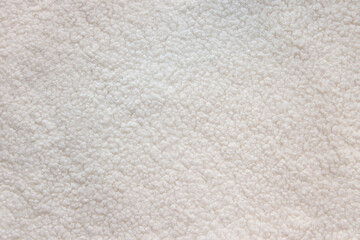White teddy bear faux fur fabric texture. Soft textile close up