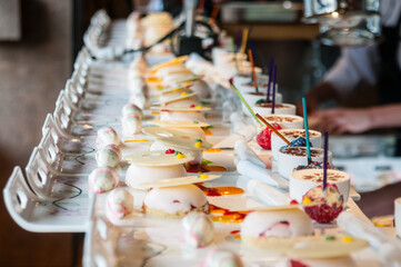 Staff prepare the dessert course at a gourmet restaurant.