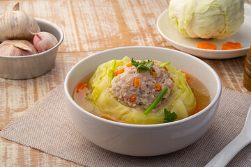 Chinese Cabbage Soup with Minced Pork .Stuffed Cabbage with Seasoned minced pork and carrot in white bowl.(Kaeng Chuet Kalampri Yad Sai)