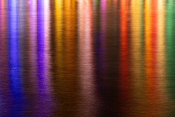 Colorful lights reflection in the water from the night cafe