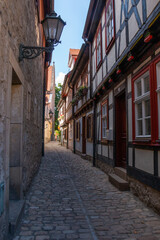 Fototapeta na wymiar Timber-framed houses lining a narrow cobblestoned street in the Old Town of Erfurt, Germany