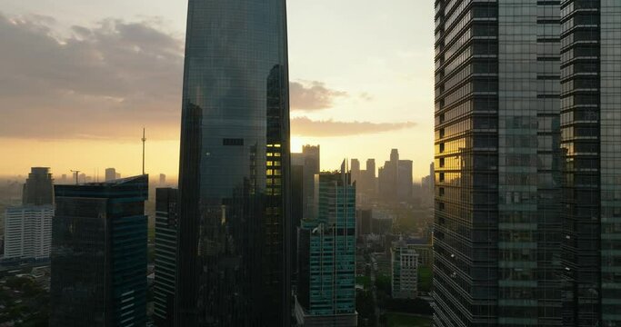 Aerial view of Jakarta city and skyscrapers at sunset. Indonesia. Urban landscape.