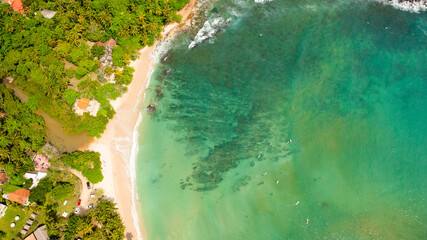 Top view of beach in the bay, a place for surfing. Hiriketiya beach, Sri Lanka.