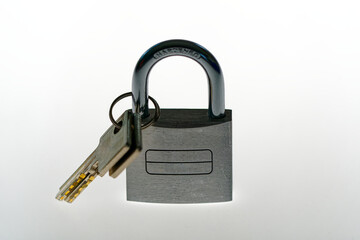 Close-up of silver colored padlock with two keys against white illuminated background. Photo taken November 19th, 2023, Zurich, Switzerland.