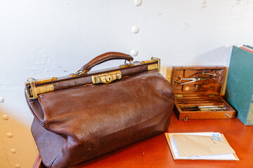 Old-fashioned doctor's surgeon's bag on a desk 