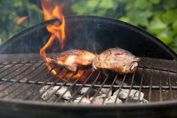 Chicken breast laying in the flames on barbecue