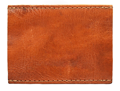 Blank brown leather label on white background, macro close up. Leather patch with stitching