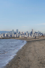 Fototapeta na wymiar Beautiful view of the skyline of Vancouver in the distance as seen from Jericho Beach in Vancouver, British Columbia, Canada