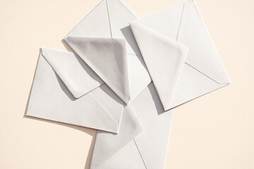 Gray paper envelopes on a beige background. Business or office concept. Copy space. Space for text. Flat lay. Top view